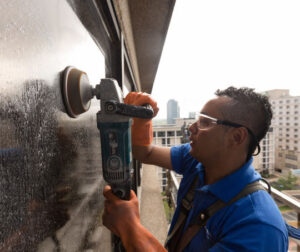 A worker cleaning a window