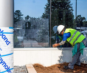 A worker cleaning a window
